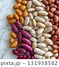 Colorful assortment of dried beans arranged on a marble surface for culinary inspiration and recipe ideas 131938582