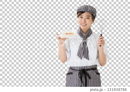 一位身穿廚師服的女士手裡拿著一塊脆餅 一位身穿廚師服的女士手裡拿著一塊脆餅 131938788