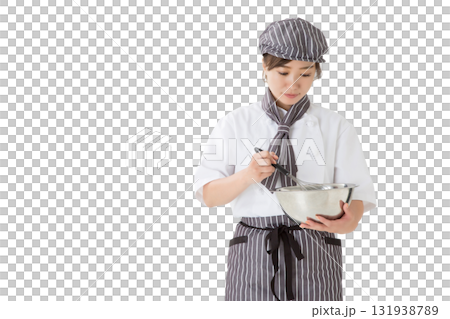 A woman wearing a chef's coat mixing whipped cream in a bowl A woman wearing a chef's coat mixing whipped cream in a bowl 131938789