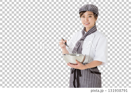 A woman wearing a chef's coat mixing whipped cream in a bowl A woman wearing a chef's coat mixing whipped cream in a bowl 131938791