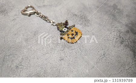 Handcrafted pumpkin-shaped keychain made of orange seed beads and glass beads Handcrafted pumpkin-shaped keychain made of orange seed beads and glass beads 131939789