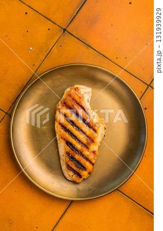 Grilled Chicken breast steak on a plate, fried poultry meat, top view. 131939929