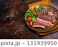 Dinner with Grilled Rib eye steak, fried dry aged beef meat. brown background. top view 131939950