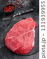 Fresh raw top sirloin steak, beautifully marbled and ready for grilling, perfect for meat lovers seeking quality. black background. top view 131939955