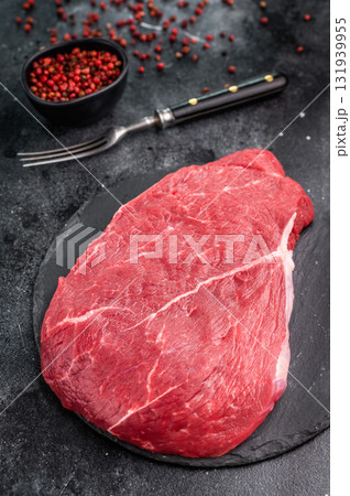 Fresh raw top sirloin steak, beautifully marbled and ready for grilling, perfect for meat lovers seeking quality. black background. top view 131939955