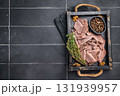 Cooked boiled sliced beef meat in wooden tray. black background. top view 131939957