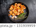 Appetizing grilled shrimp prawns served on a platter, perfect for elegant dinners or casual gatherings with friends. black background. top view 131939959