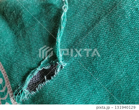 Torn fabric. Frayed cloth background for sample, presentation, safety issue, excessive acid wash warning etc 131940129