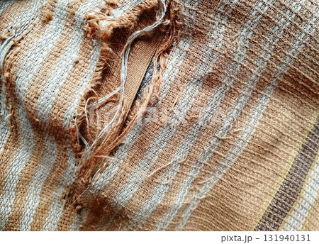 Torn fabric. Frayed cloth background for sample, presentation, safety issue, excessive acid wash warning etc 131940131
