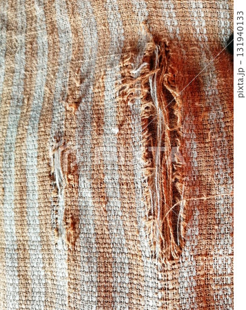 Torn fabric. Frayed cloth background for sample, presentation, safety issue, excessive acid wash warning etc 131940133