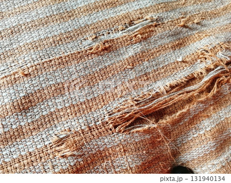 Torn fabric. Frayed cloth background for sample, presentation, safety issue, excessive acid wash warning etc 131940134
