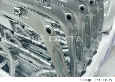 Batch of Unpainted Metal Car Hoods Ready for car Assembly in the Welding Shop of car Assembly Plant Batch of Unpainted Metal Car Hoods Ready for car Assembly in the Welding Shop of car Assembly Plant 131941019