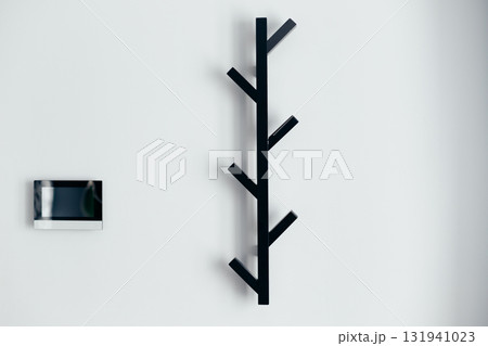 Black metal empty rack for outerwear on grey wall. Black metal empty rack for outerwear on grey wall. 131941023