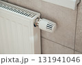White heating radiator with thermostatic temperature regulator. Heating season. Energy saving 131941046