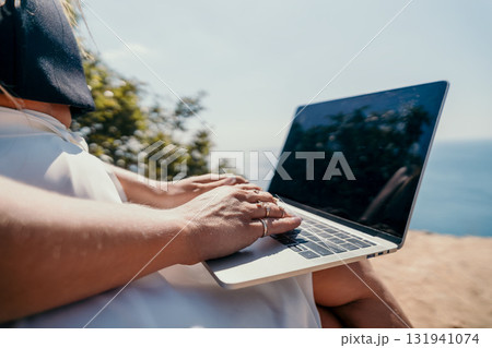 Woman Typing on Laptop with Ocean View Woman Typing on Laptop with Ocean View 131941074