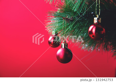 Red Christmas Balls on Christmas Tree on Red Background 131942753