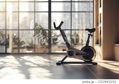 Modern exercise bike standing on a wooden floor in a sunny room with big windows overlooking a city Modern exercise bike standing on a wooden floor in a sunny room with big windows overlooking a city 131943233