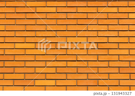 Close up view of orange brick fence with clean horizontal lines and neat geometric pattern. Smooth texture, ideal for use as background, construction material concept, architectural design element 131943327