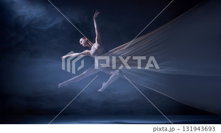 Ballet dancer suspended in stretched fabric performing stage leap Ballet dancer suspended in stretched fabric performing stage leap 131943693