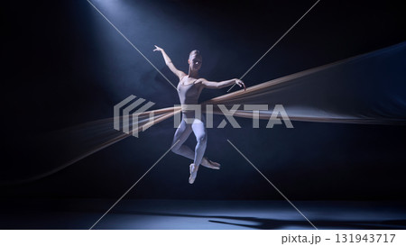 Ballet dancer suspended in fabric mid-air performing dynamic pose on stage Ballet dancer suspended in fabric mid-air performing dynamic pose on stage 131943717