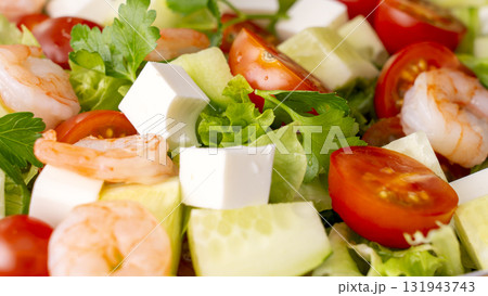 A close-up of a vegetable salad with shrimp. Fresh vegetables, feta cheese, and shrimp make for a healthy meal. A close-up of a vegetable salad with shrimp. Fresh vegetables, feta cheese, and shrimp make for a healthy meal. 131943743