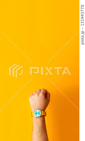 a hand wearing a wristwatch, set against a bright yellow background, to convey the value of time management sell time during the summer or autumn seasons. sell time vertical yellow banner a hand wearing a wristwatch, set against a bright yellow background, to convey the value of time management sell time during the summer or autumn seasons. sell time vertical yellow banner 131943778