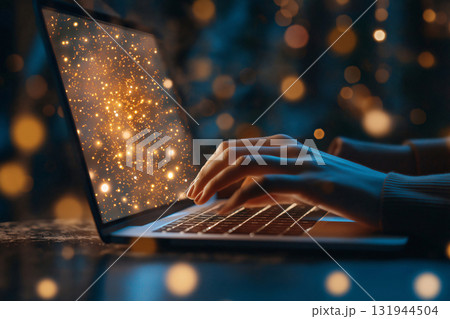 Woman typing on laptop keyboard with abstract golden Christmas tree on the screen in the evening Woman typing on laptop keyboard with abstract golden Christmas tree on the screen in the evening 131944504