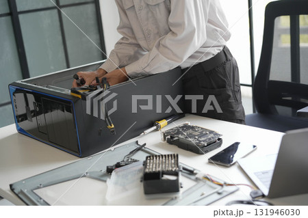 Computer hardware technician fixing and assemble computer PC. 131946030