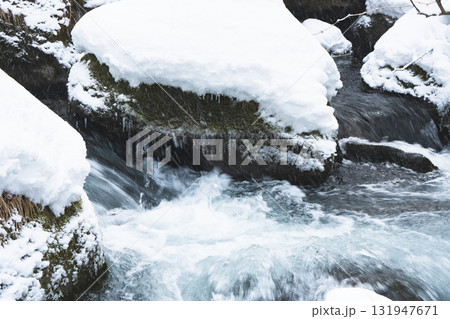 雪に覆われた岩を流れる冬の清流 雪に覆われた岩を流れる冬の清流 131947671