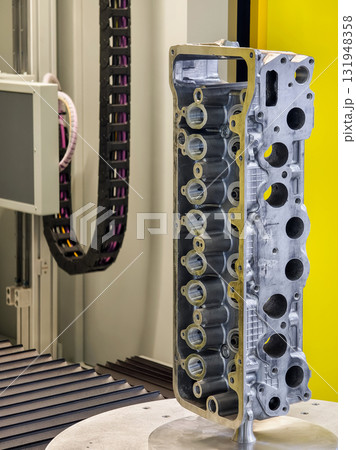 Precision machining of an engine block component in a manufacturing facility during daytime operations 131948358