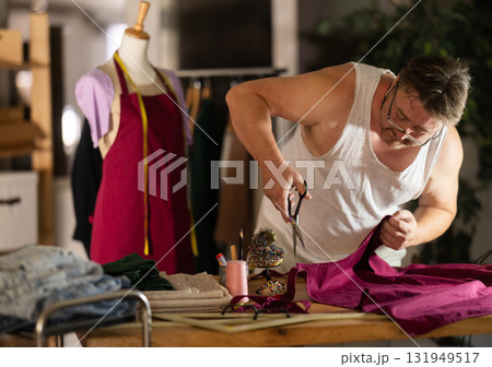 Man seamstress work with scissors and cutting 131949517