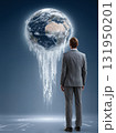 Businessman Contemplating a Melting Planet Earth and the Climate Crisis 131950201
