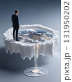 Businessman Contemplating a Melting Planet Earth and the Climate Crisis 131950202