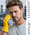 Construction Worker Wearing Mask and Yellow Jacket Outdoors 131950297