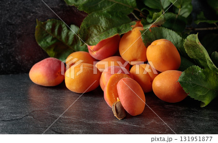 Apricots on a black stone table. Apricots on a black stone table. 131951877