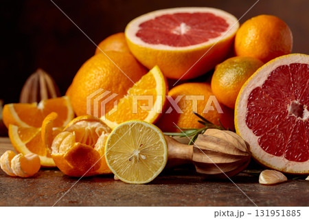 Citrus fruits on a brown table. Citrus fruits on a brown table. 131951885