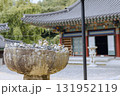 A pile of stones, used to make wishes, is placed on a stone table at Jangansa Temple in Gijang, Busan, South Korea. Landscape. 131952119