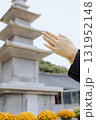 A woman's hand praying in front of the stone pagoda at Jangansa Temple in Gijang, Busan, South Korea. 131952148