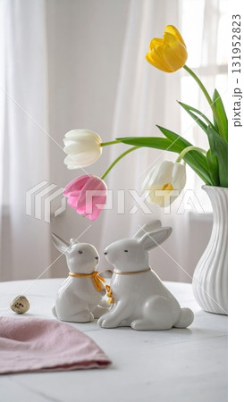 A vibrant Easter decoration for the spring holiday featuring a bunny, tulips, and colorful eggs in a basket A vibrant Easter decoration for the spring holiday featuring a bunny, tulips, and colorful eggs in a basket 131952823