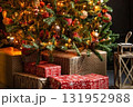 Christmas tree decorated with festive ornaments and glowing lights, with holiday presents on the floor. Winter celebration and seasonal decor concept. 131952988