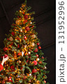 Decorated Christmas tree with glowing string lights and festive ornaments. Holiday season celebration decoration for Winter. 131952996