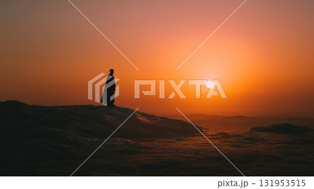 Silhouette of jesus christ in cloak standing on rocky hill at sunset light Silhouette of jesus christ in cloak standing on rocky hill at sunset light 131953515