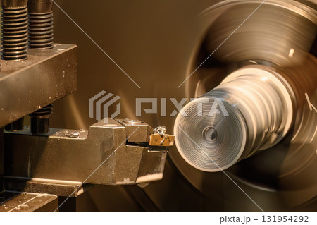 Close up scene the lathe machine finish cut metal shaft parts with liquid coolant method. Close up scene the lathe machine finish cut metal shaft parts with liquid coolant method. 131954292
