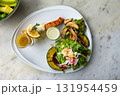 Top view of roasted salmon steak cooked with various vegetable salad. 131954459