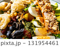 Closeup of roasted salmon steak with avocado, cereals, boil eggs, olive  and mixed fresh vegetables in white ceramic plate. 131954461