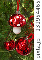 Christmas tree branches with a red Fly agaric toy as decoration 131954465