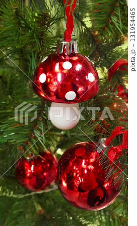 Christmas tree branches with a red Fly agaric toy as decoration 131954465