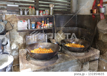 Rustic Basket Of Small Orange Fruits On Wooden Table Beside Rustic Basket Of Small Orange Fruits On Wooden Table Beside 131954635