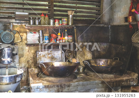 Sept 27 2025 Rustic Kitchen Scene With Large Woks, Shelves Of Condiments 131955263