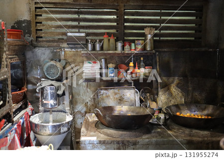 Sept 27 2025 Rustic Kitchen Scene With Large Woks, Shelves Of Condiments 131955274